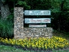 Sign at bottom of the driveway with Marigolds